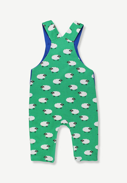 A baby's green sleeveless romper with an all-over sheep print and blue shoulder straps, shown flat against a light gray background.
