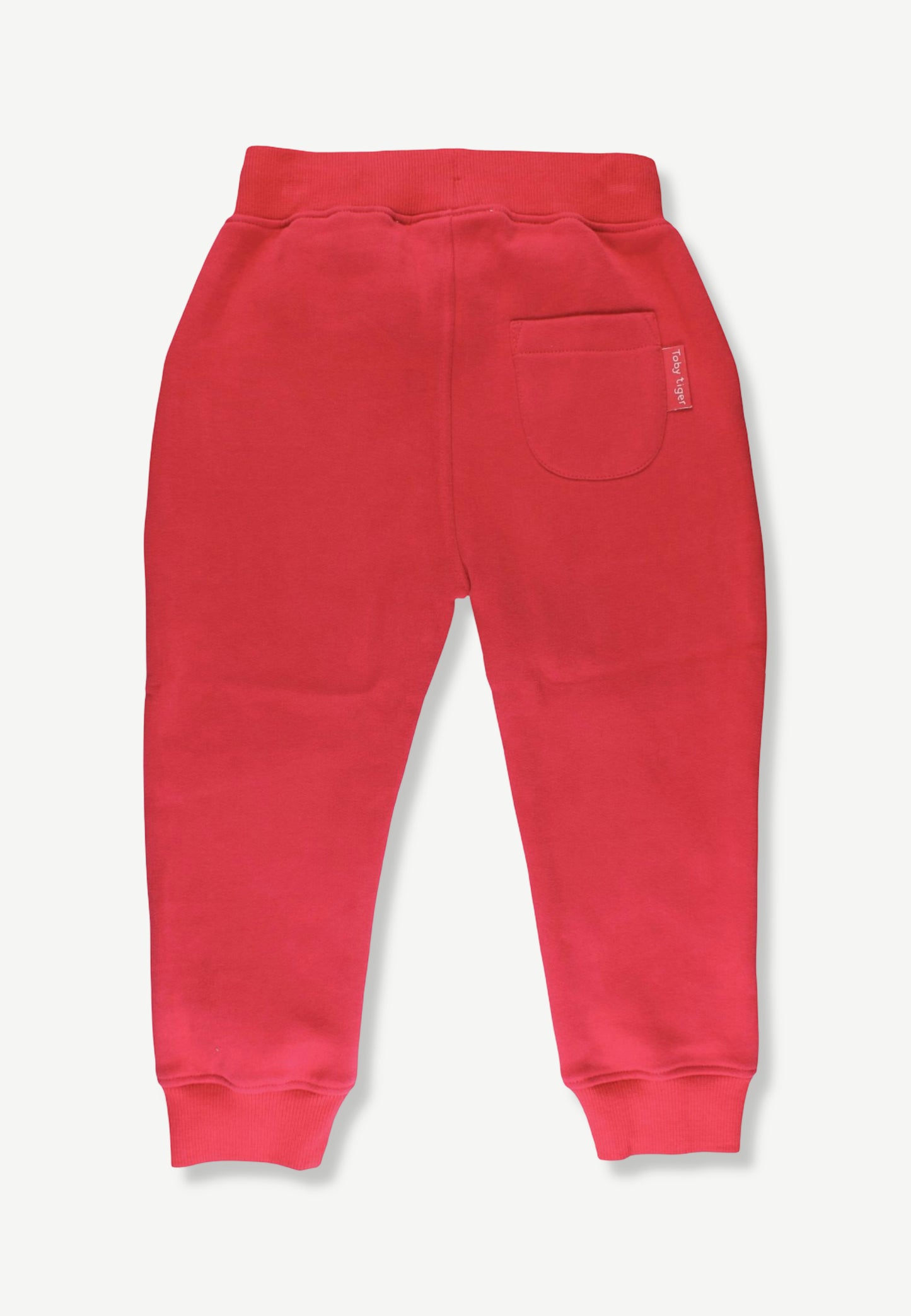 Red sweatpants shown from the back, featuring a wide elastic waistband, a side pocket, and ribbed ankle cuffs, photographed against a light gray background.