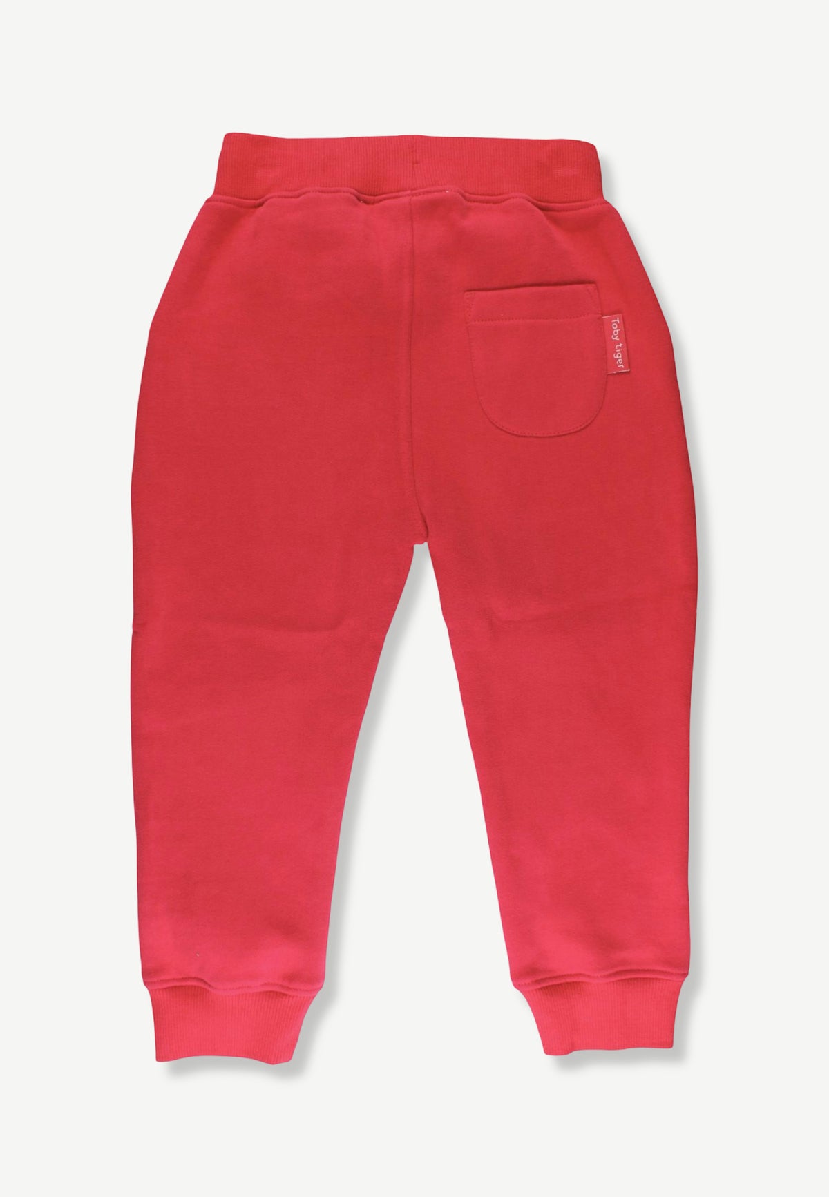 Red sweatpants shown from the back, featuring a wide elastic waistband, a side pocket, and ribbed ankle cuffs, photographed against a light gray background.