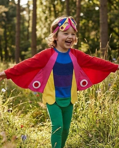 Child in colorful outfit with butterfly wings in a forest