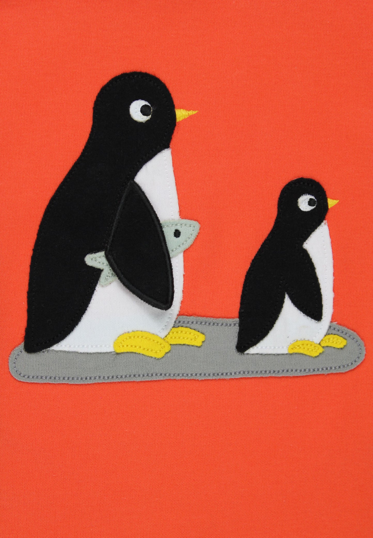Two penguins on a red background