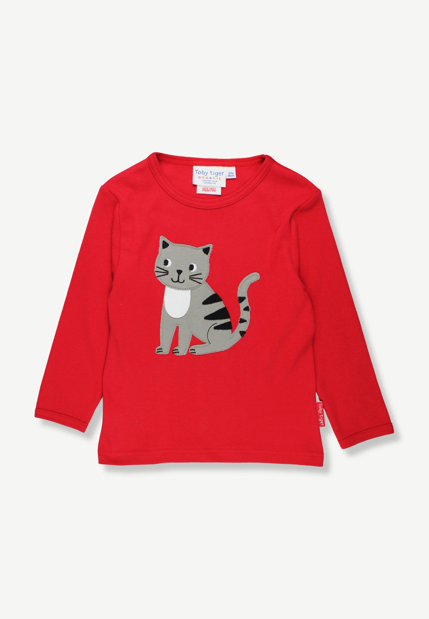 A red long-sleeve children's t-shirt featuring a cartoon cat graphic on the front, displayed flat against a light gray background.