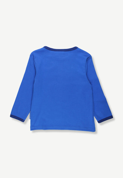 A bright blue long-sleeve shirt shown from the back, featuring dark blue ribbed trim on the collar and cuffs, laid flat against a light off-white background.