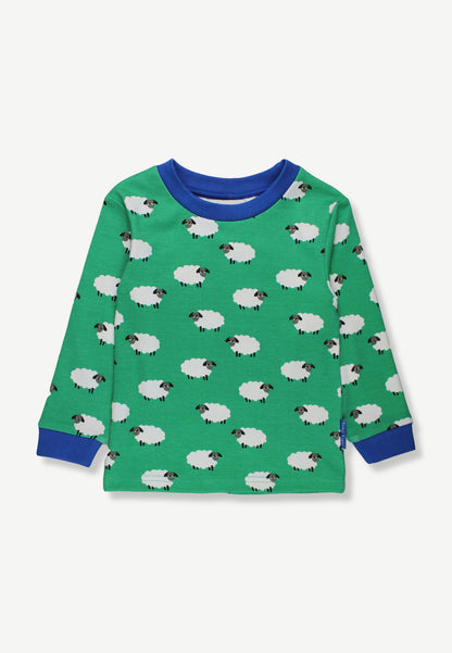 A green long-sleeve children's top with an all-over sheep print, featuring blue ribbed collar, cuffs, and hem, displayed on a light gray background.