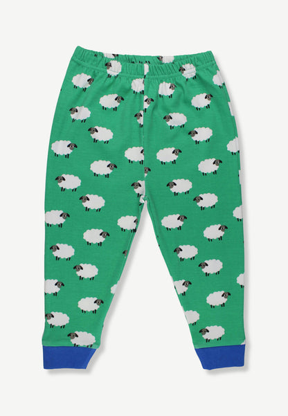 Green children's jogger pants with an all-over sheep print and blue cuffed hems, shown flat against a light gray background.