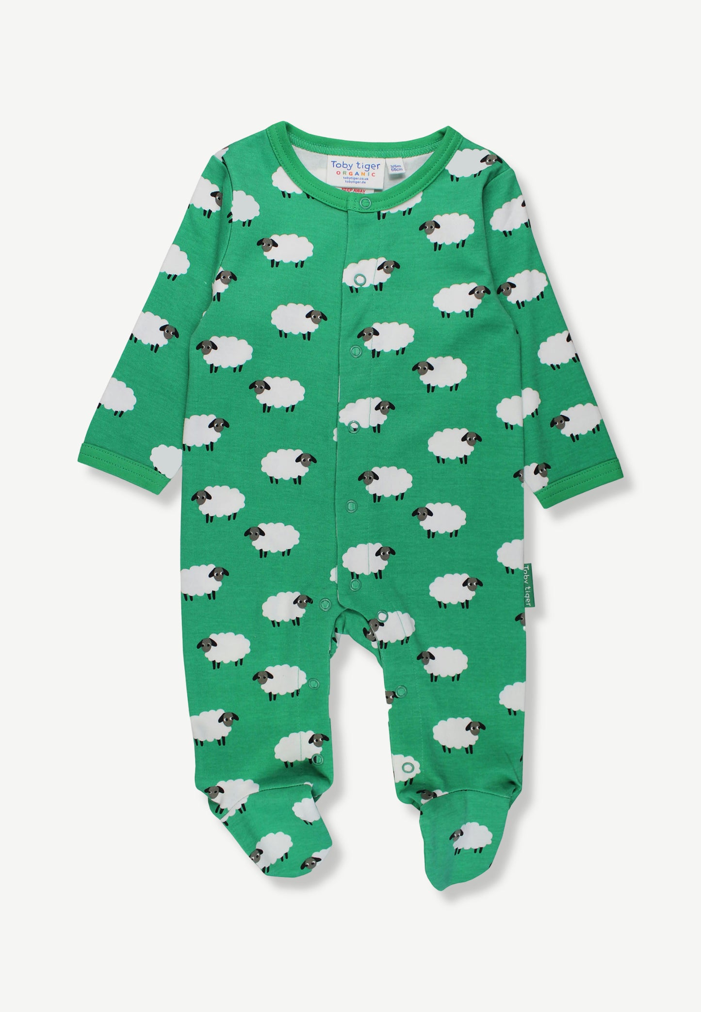 A baby long-sleeve footed sleeper in bright green, featuring an all-over white sheep print with black faces, shown flat on a light gray background.