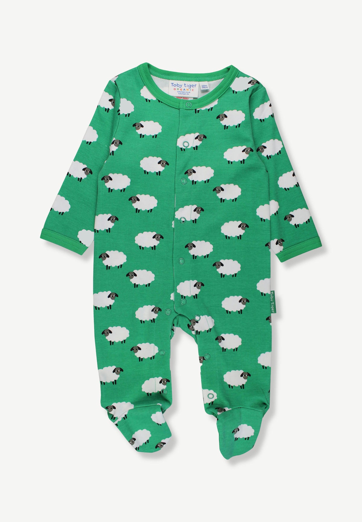 A baby long-sleeve footed sleeper in bright green, featuring an all-over white sheep print with black faces, shown flat on a light gray background.