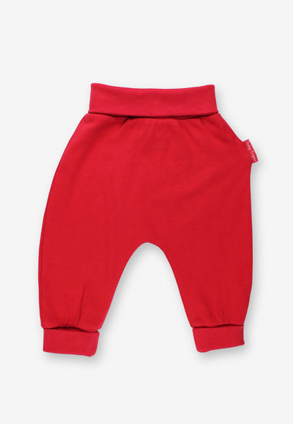 Red baby pants with an elastic waistband and cuffed ankles, shown flat on a light gray background.