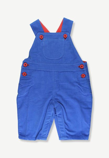 A pair of blue corduroy baby overalls with red buttons and red inner shoulder straps, laid flat on a light off-white background.
