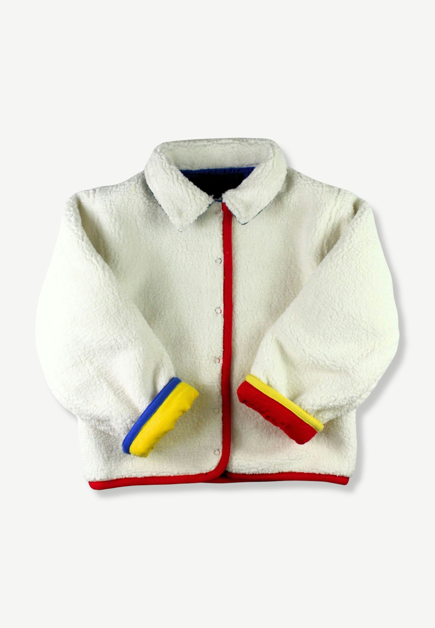 A white sherpa fleece jacket with red and yellow trim details, featuring a button-up front, pointed collar, and contrasting cuffs.