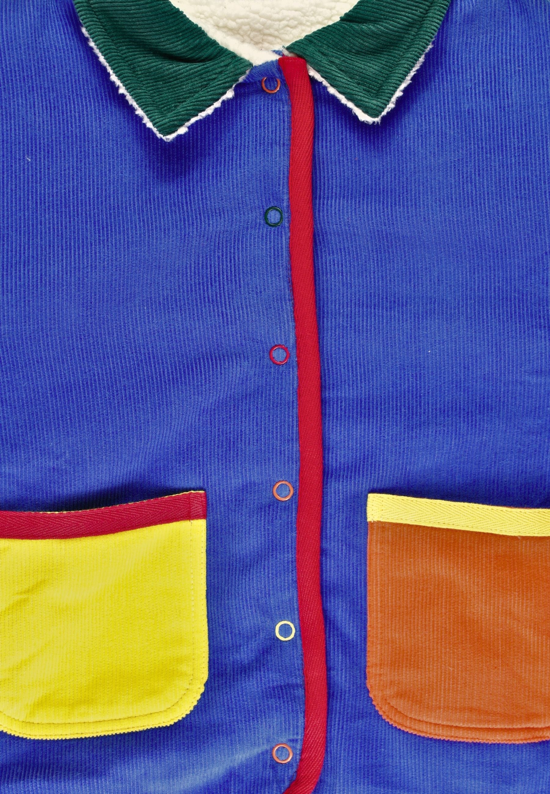 Colorful jacket with blue body, green collar, red lining, yellow pocket, and brown patch.