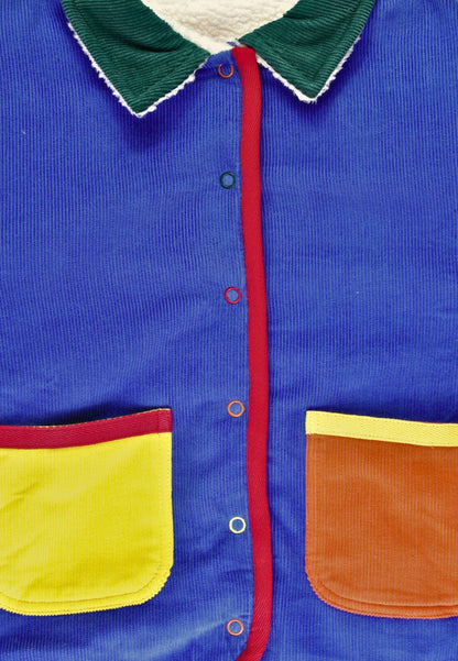 Colorful jacket with blue body, green collar, red lining, yellow pocket, and brown patch.