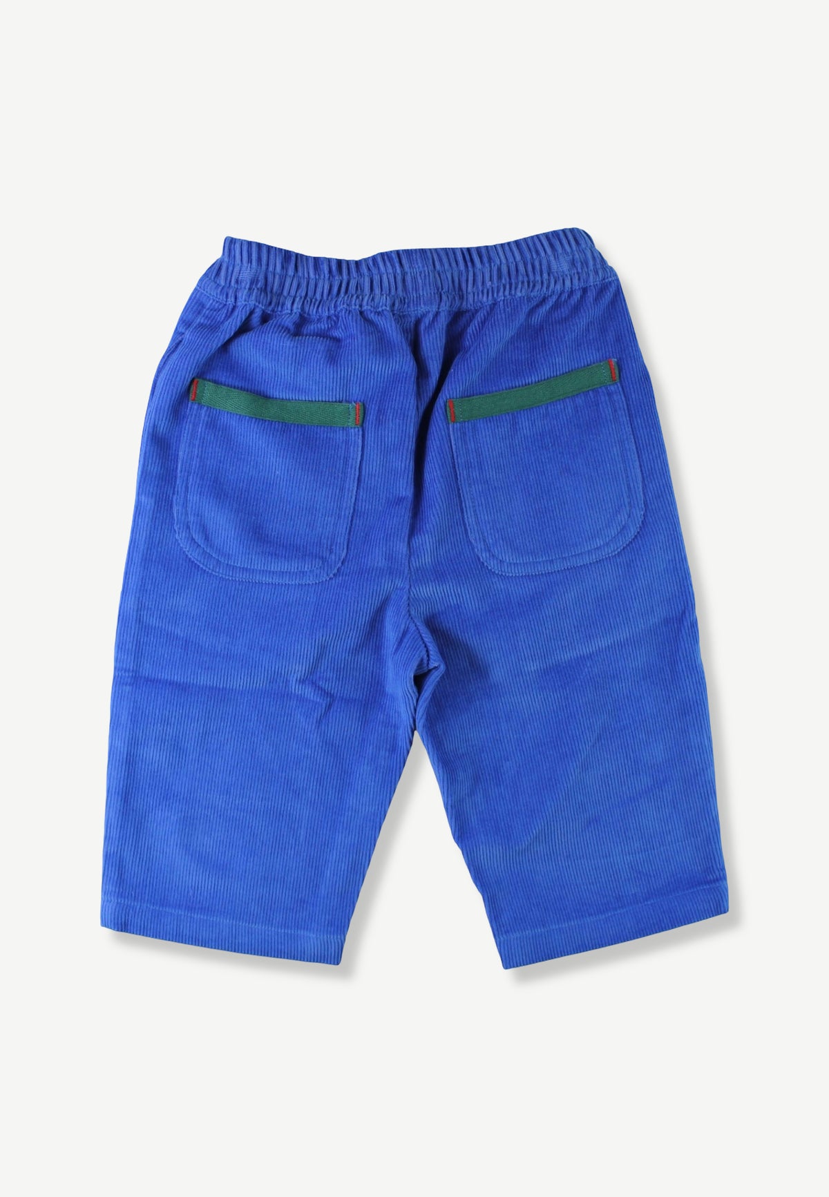 Blue corduroy shorts with an elastic waistband and two back pockets featuring green trim, shown from the back on a light off-white background.