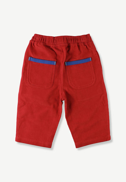 Red cotton pants with an elastic waistband and two back pockets featuring blue stripe accents, shown from the back on a light gray background.